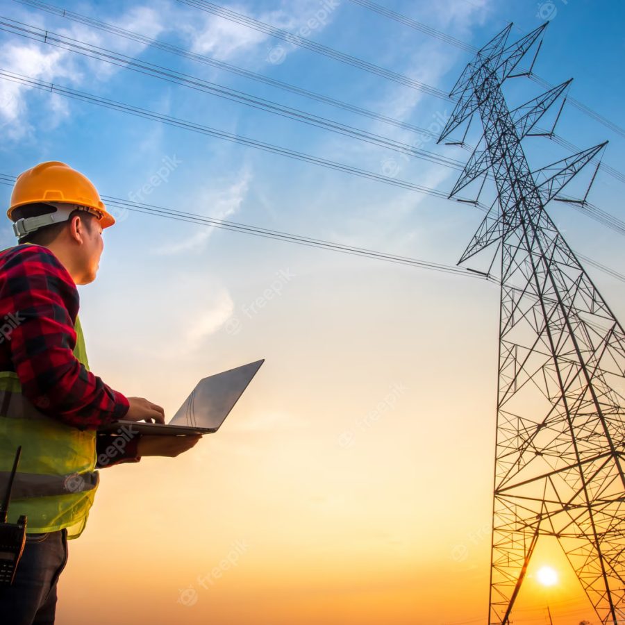picture-electrical-engineer-using-notebook-computer-standing-power-station-see-planning-work-by-producing-electrical-energy-high-voltage-electrodes_140555-388